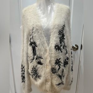 Gorgeous sweater, size large with embroidered black flowers.